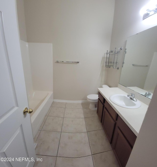 bathroom featuring tile patterned floors, vanity, and toilet