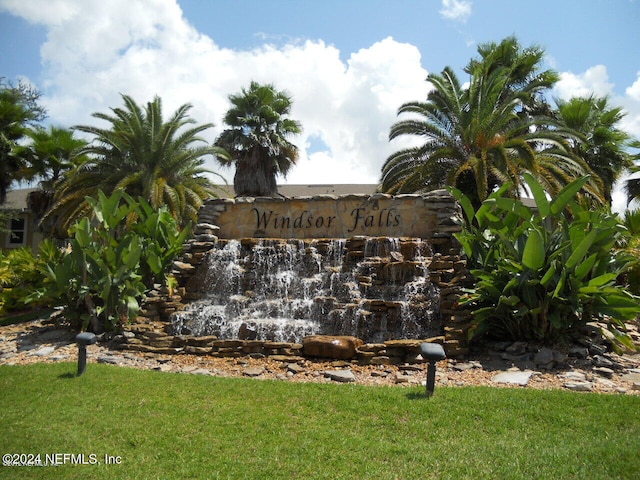 community / neighborhood sign with a yard