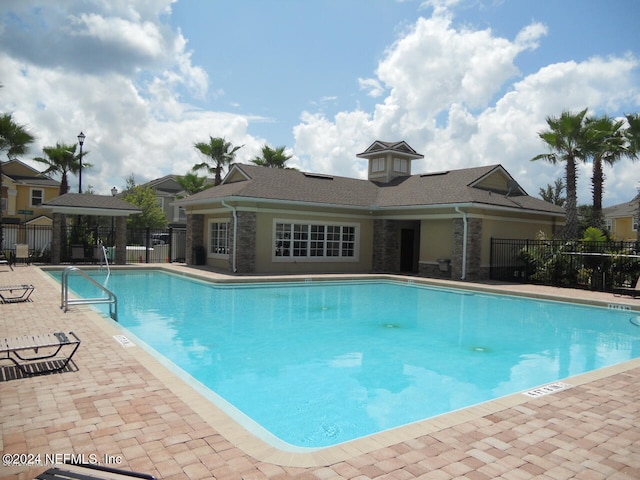 view of swimming pool featuring a patio area