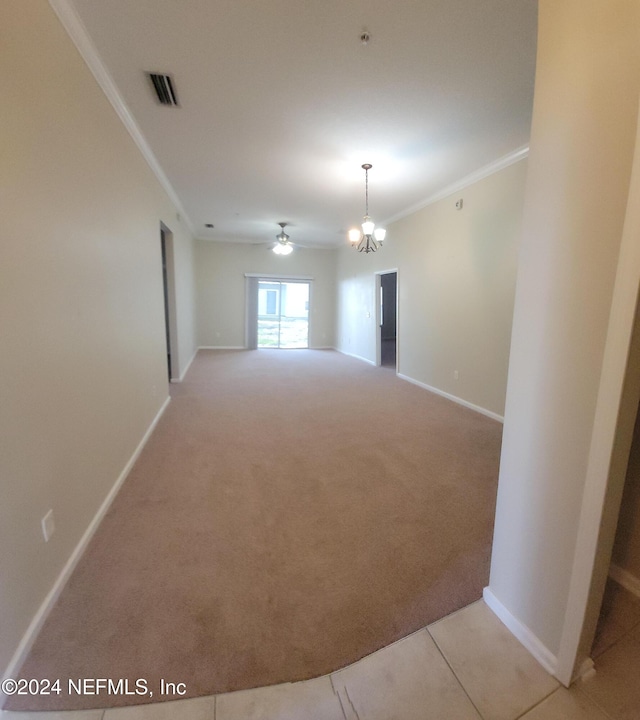 unfurnished room featuring ceiling fan with notable chandelier, light colored carpet, and crown molding