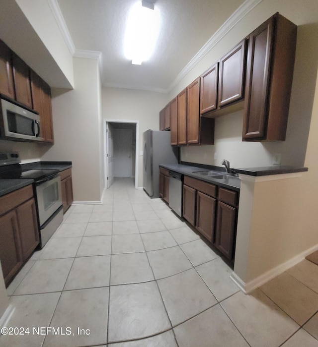 kitchen featuring light tile patterned floors, ornamental molding, sink, and appliances with stainless steel finishes