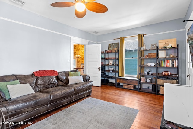 living room featuring hardwood / wood-style floors and ceiling fan