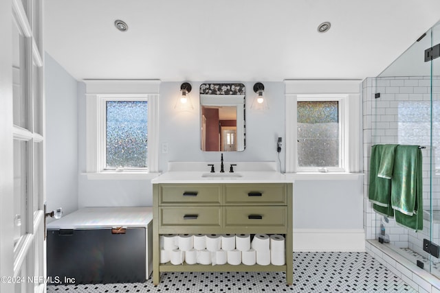 bathroom with vanity and a shower with shower door