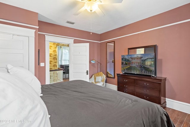 bedroom with hardwood / wood-style floors and ceiling fan