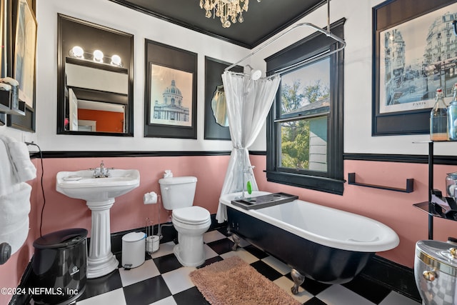 bathroom with a tub to relax in, toilet, and a notable chandelier