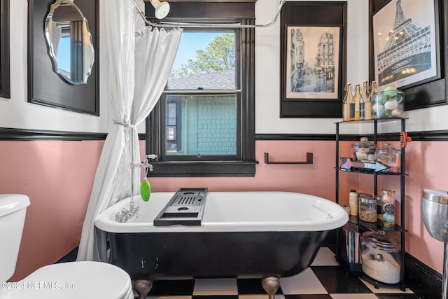 bathroom featuring a tub and toilet