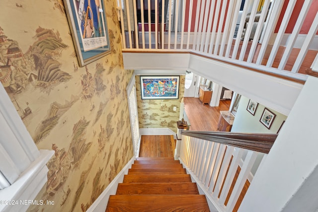 stairway with hardwood / wood-style floors