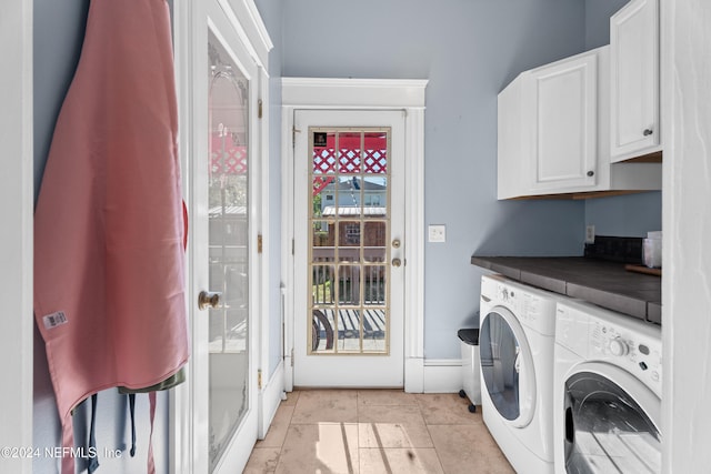 laundry room featuring cabinets, independent washer and dryer, and light tile patterned floors