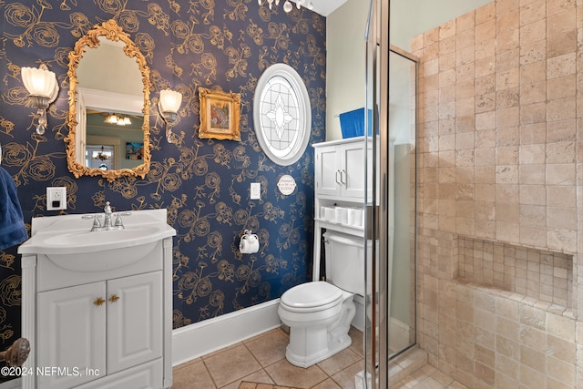 bathroom with tile patterned flooring, vanity, an enclosed shower, and toilet