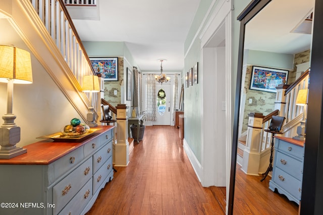 hallway featuring a chandelier and hardwood / wood-style flooring