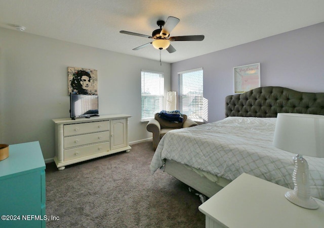 bedroom with ceiling fan and dark carpet