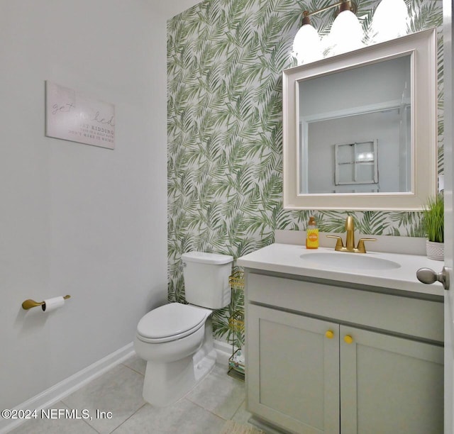 bathroom featuring tile patterned floors, vanity, and toilet