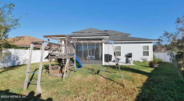 back of house with a lawn, a sunroom, and a pergola