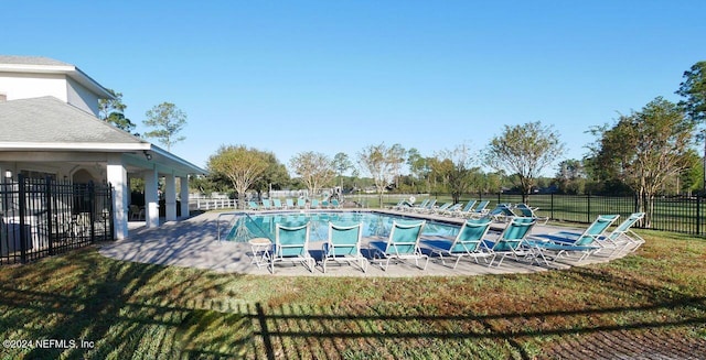 view of pool with a yard and a patio area