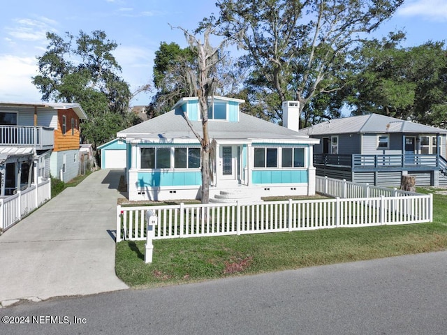 view of front of property featuring an outdoor structure, a front yard, and a garage