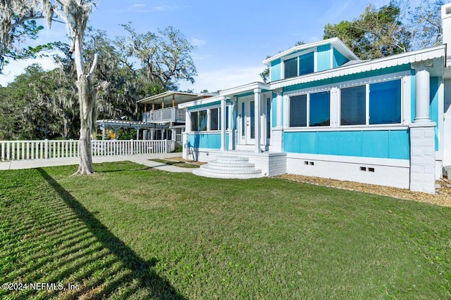 rear view of house with a lawn