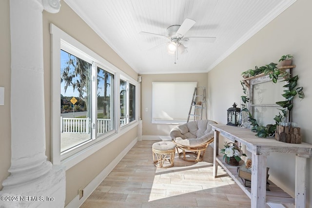 sunroom / solarium featuring ceiling fan