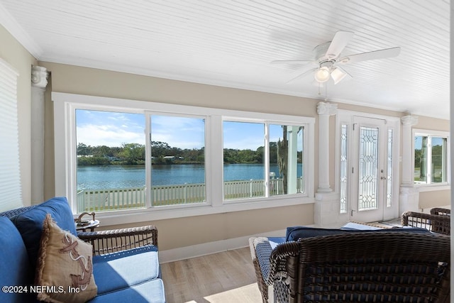 sunroom / solarium with ceiling fan, a healthy amount of sunlight, and a water view