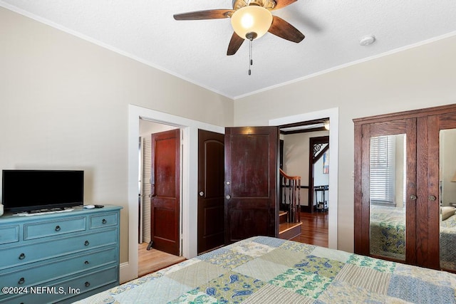 bedroom with ceiling fan, light hardwood / wood-style floors, ornamental molding, and french doors