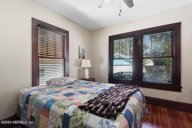 bedroom with ceiling fan and dark hardwood / wood-style floors