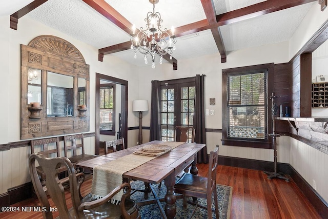 dining area with french doors, an inviting chandelier, a textured ceiling, beamed ceiling, and dark hardwood / wood-style flooring