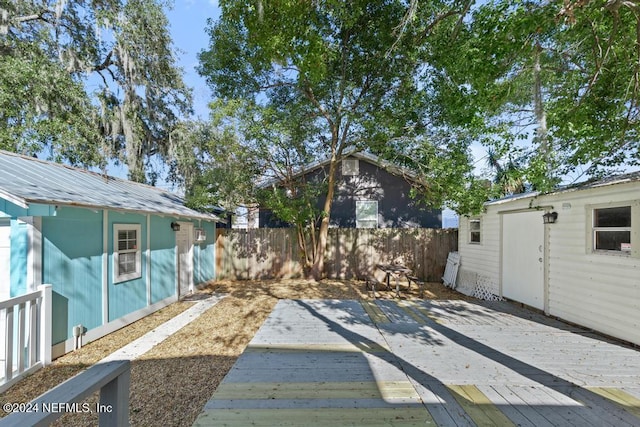 view of yard with a deck and an outdoor structure