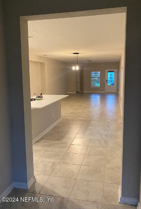 corridor with light tile patterned floors