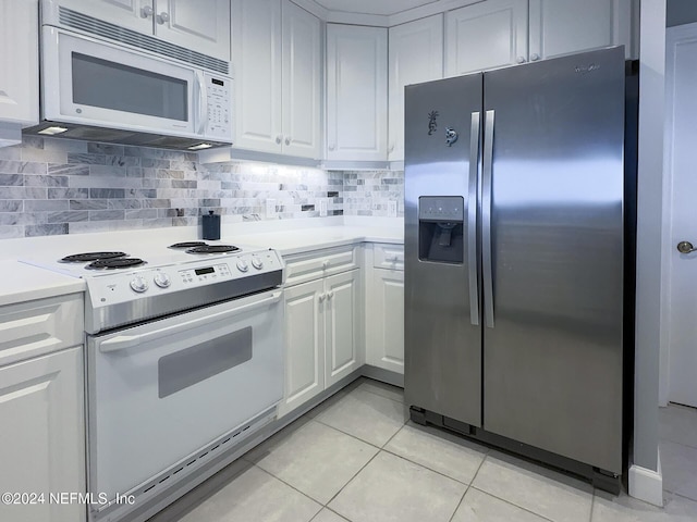 kitchen featuring white cabinets, white appliances, backsplash, and light tile patterned floors