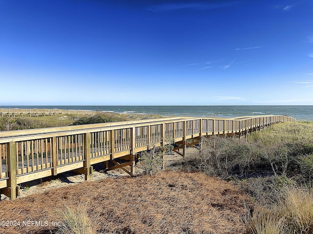 exterior space with a water view and a beach view