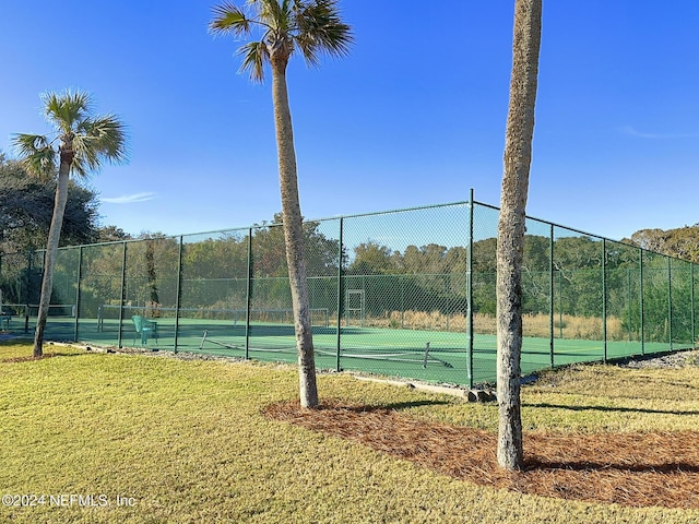 view of sport court featuring a yard