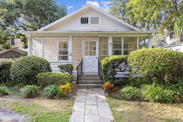 bungalow-style house featuring a sunroom