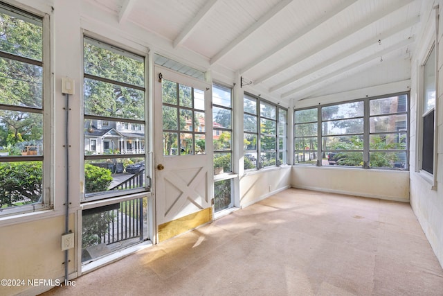 unfurnished sunroom with lofted ceiling with beams