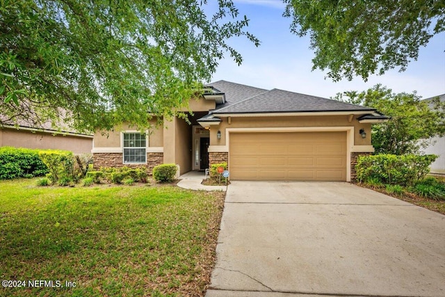 view of front facade featuring a front yard and a garage