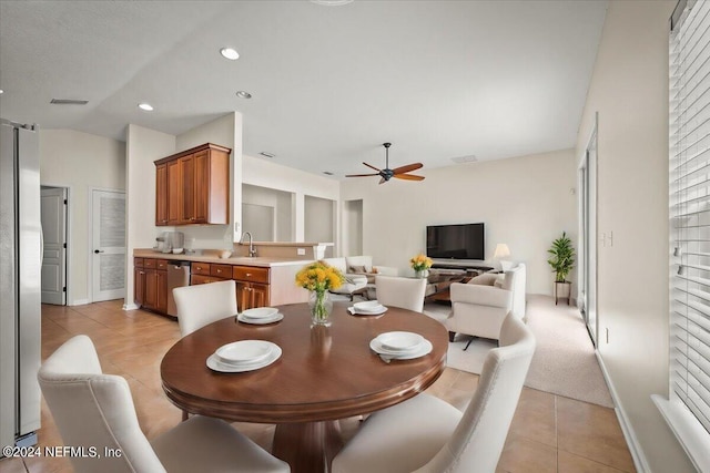 dining room with ceiling fan, sink, and light tile patterned floors