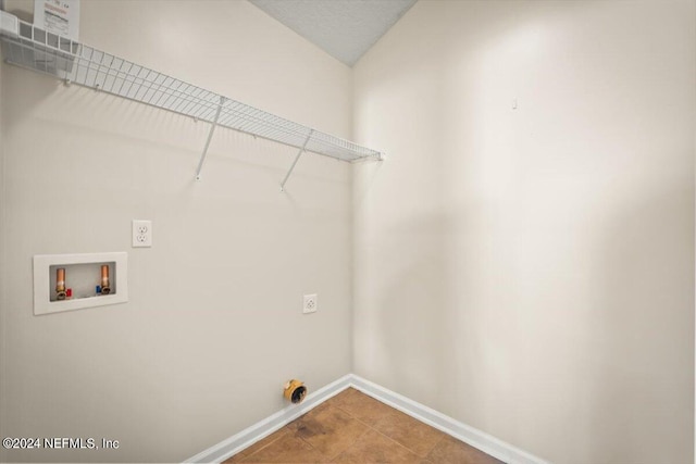 clothes washing area featuring washer hookup, tile patterned floors, and electric dryer hookup