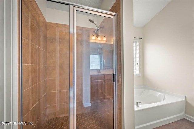 bathroom featuring separate shower and tub and vaulted ceiling