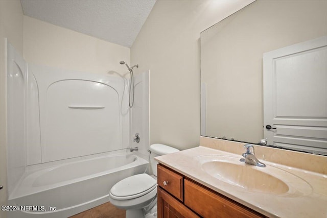 full bathroom featuring vanity, a textured ceiling, shower / washtub combination, tile patterned flooring, and toilet