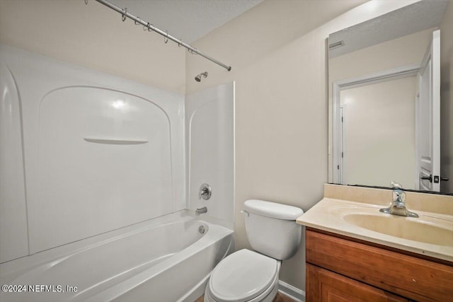 full bathroom with vanity, toilet, washtub / shower combination, and a textured ceiling