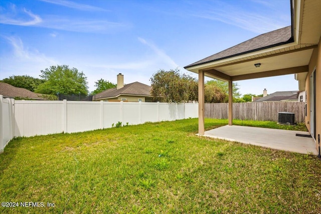 view of yard with cooling unit and a patio area