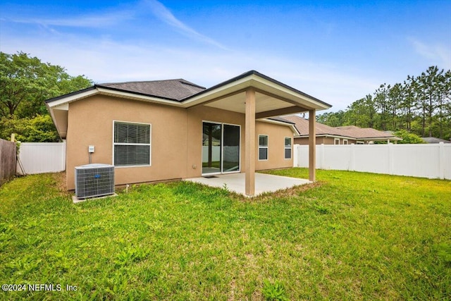 back of property featuring a yard, a patio, and central AC