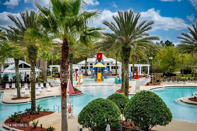 view of swimming pool with pool water feature