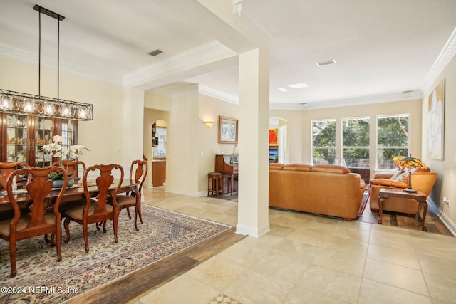 dining area featuring an inviting chandelier, crown molding, and light hardwood / wood-style flooring