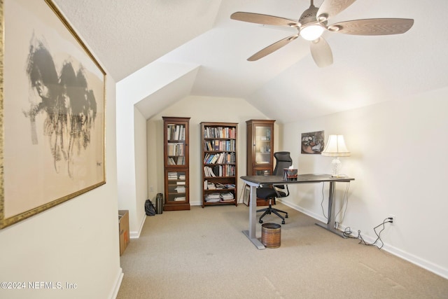 carpeted home office with ceiling fan and lofted ceiling