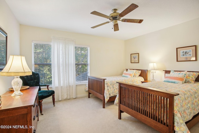 bedroom with ceiling fan and light carpet