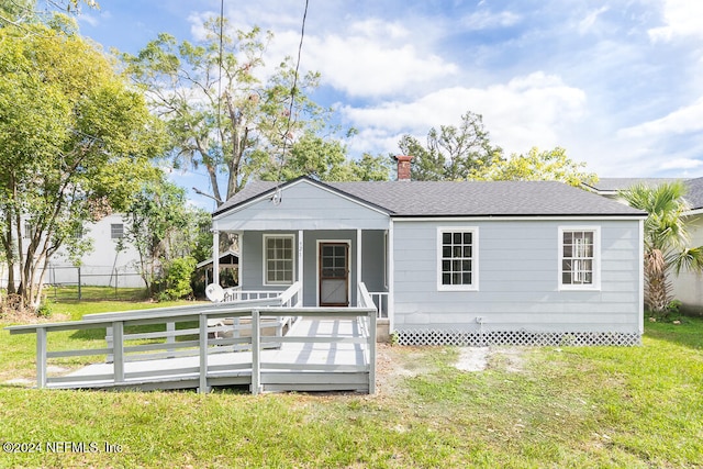 view of front facade with a front lawn, a porch, and a deck