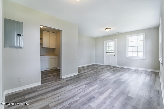 spare room featuring hardwood / wood-style floors and electric panel