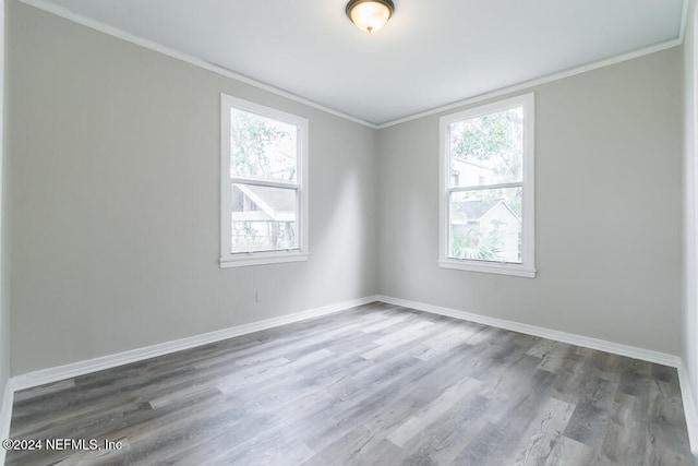 unfurnished room featuring hardwood / wood-style flooring and ornamental molding