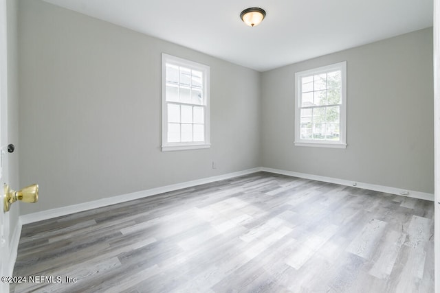 unfurnished room with light wood-type flooring