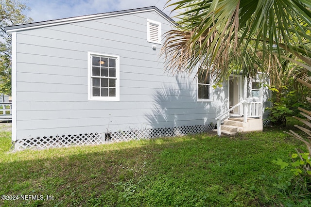 view of side of property with a lawn