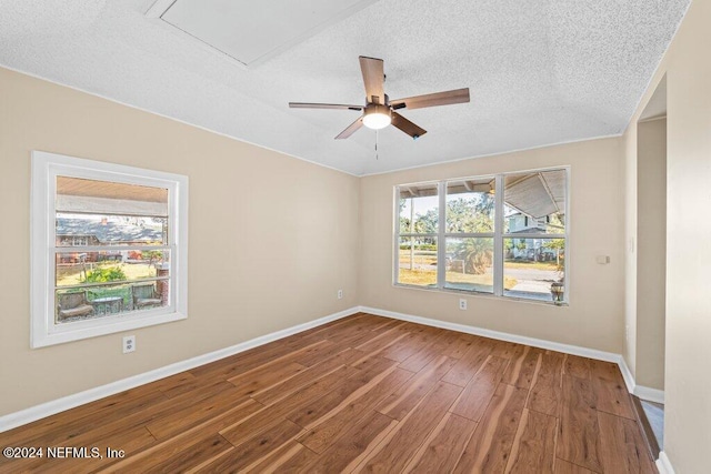 spare room with hardwood / wood-style flooring, ceiling fan, and a textured ceiling